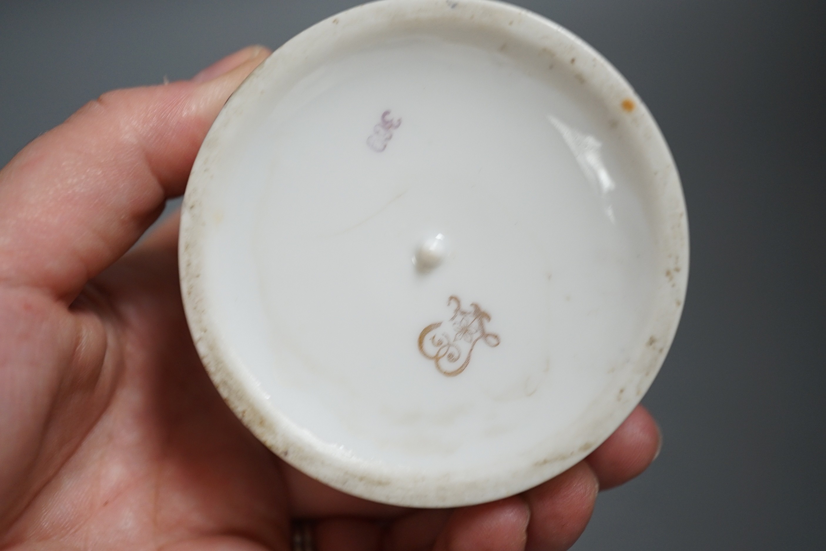 A Continental circular porcelain pot and cover, a plaque and a matchbox cover